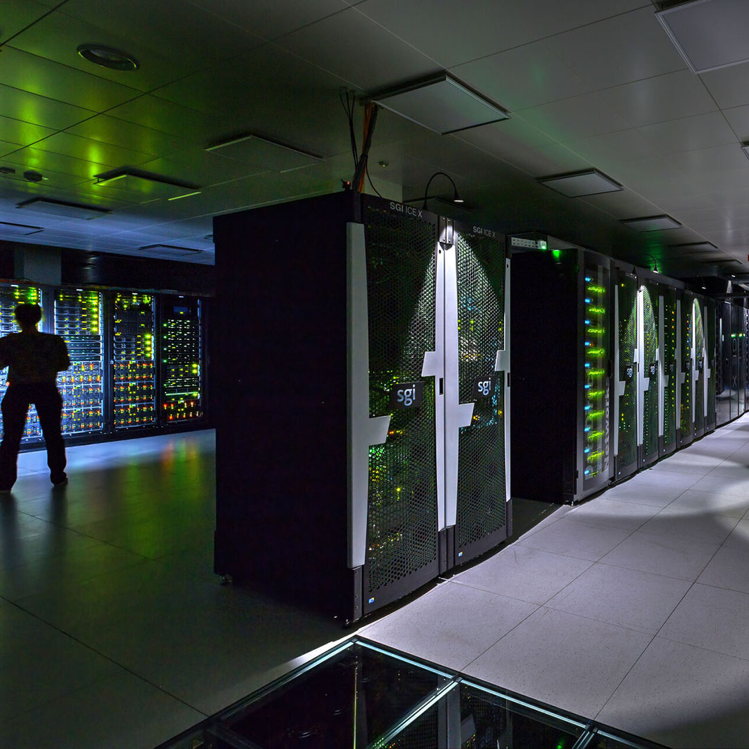 Server room with server racks and a person.